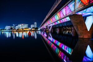 Night shot of Tempe town lake with the famous rainbow colored bridge in Papago Park Phoenix, USA